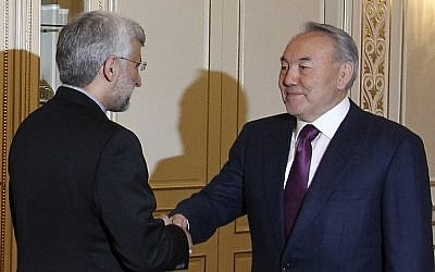 Chief Iranian nuclear negotiator Saeed Jalili, left, shakes hands with Kazakhstan's President Nursultan Nazarbayev prior to their talks in Almaty, Kazakhstan, Monday.(photo credit: AP/Pavel Mikheyev)