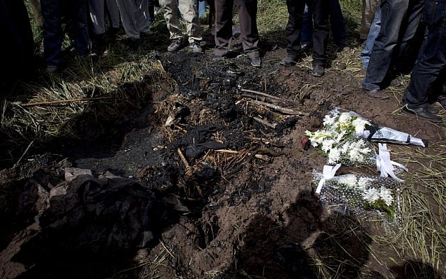 Flowers are laid by Japanese travel agent Okumura Hatsuko and Luxor's mayor Ezzat Saad, both unseen, to pay respect to Japanese tourists that died from a hot air balloon accident, in Luxor, Egypt, Wednesday, Feb. 27, 2013(photo credit: AP/ Nasser Nasser)