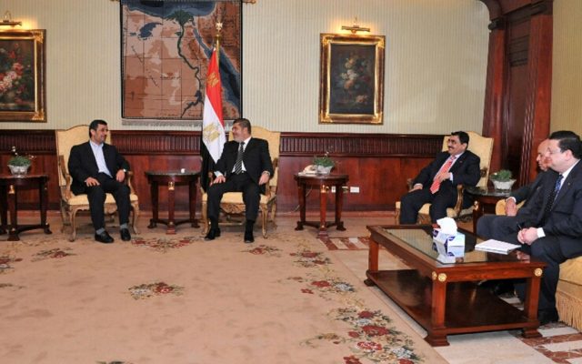 Iran's President Mahmoud Ahmadinejad, left, and Egyptian President Mohammed Morsi, center, meet in Cairo, Egypt, Tuesday, February 5 (photo credit: AP/Egyptian Presidency) Iran's President Mahmoud Ahmadinejad, left, and Egyptian President Mohammed Morsi, center, meet in Cairo, Egypt, Tuesday, February 5 (photo credit: AP/Egyptian Presidency)
