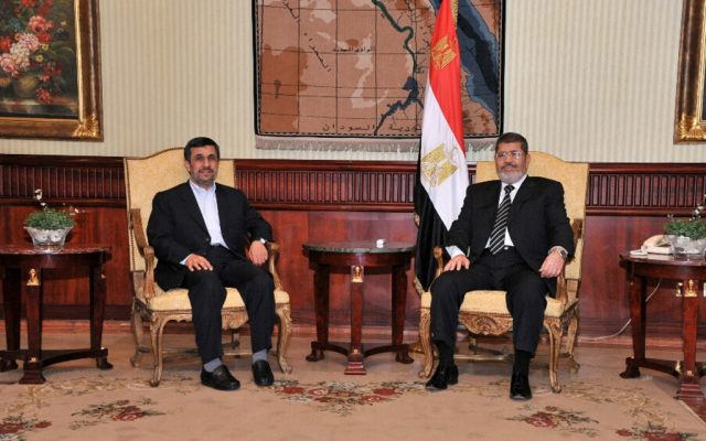 Iranian President Mahmoud Ahmadinejad, left, and Egyptian President Mohammed Morsi, in Cairo, Egypt, Tuesday, Feb. 5, 2013. (photo credit:AP/Egyptian)