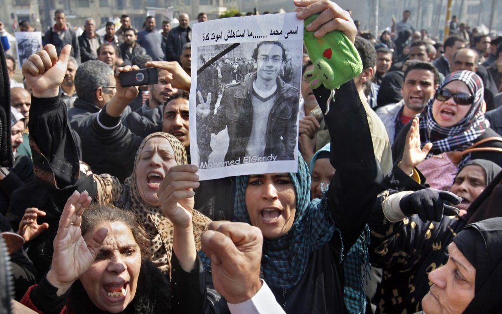 Egyptian relatives of Mohammed el-Gindy, a 28-year-old activist, who died early Monday of wounds sustained during clashes last Friday near the presidential palace, display his picture as they shout anti-president Morsi slogans during his funeral procession in Tahrir Square, Cairo, Egypt, Monday, Feb. 4 (photo credit: AP/Amr Nabil) Egyptian relatives of Mohammed el-Gindy, a 28-year-old activist, who died early Monday of wounds sustained during clashes last Friday near the presidential palace, display his picture as they shout anti-president Morsi slogans during his funeral procession in Tahrir Square, Cairo, Egypt, Monday, Feb. 4 (photo credit: AP/Amr Nabil)