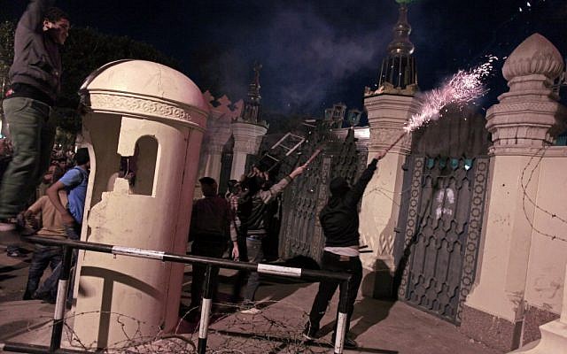 Egyptian protesters set off fireworks at the presidential palace during a demonstration in Cairo, Egypt, Friday, Feb. 8 (photo credit: AP/Khalil Hamra)