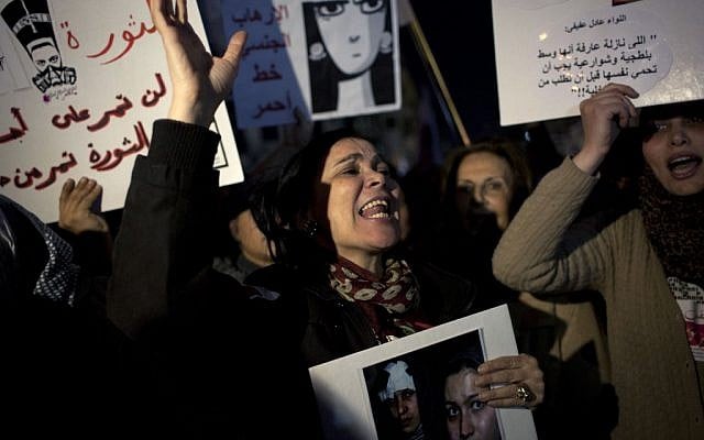 Egyptian woman activists chant slogans while taking part in a protest against sexual harassment and against the Islamist dominated Shura Council blaming women for the attacks against them, in Cairo, Egypt, Tuesday, Feb. 12 (photo credit: AP/Nasser Nasser) Egyptian woman activists chant slogans while taking part in a protest against sexual harassment and against the Islamist dominated Shura Council blaming women for the attacks against them, in Cairo, Egypt, Tuesday, Feb. 12 (photo credit: AP/Nasser Nasser)