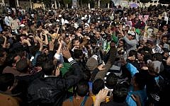 Hard-core soccer fans chant anti-president Mohammed Morsi slogans while attending a rally in front of the provincial government headquarters in Port Said, Egypt on Friday (photo credit: AP/Nasser Nasser)