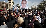 Egyptian protesters chant anti-Morsi slogans and carry posters with pictures of victims of recent violence and their names in Port Said, Egypt, February 22, 2013. (photo credit: AP/Nasser Nasser)