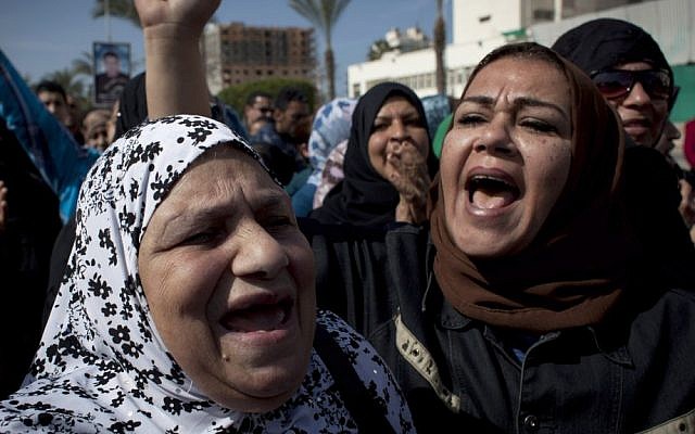 Female protesters chant anti-President Mohammed Morsi slogans in Port Said, Egypt, (photo credit: AP/Nasser Nasser) Female protesters chant anti-President Mohammed Morsi slogans in Port Said, Egypt, (photo credit: AP/Nasser Nasser)