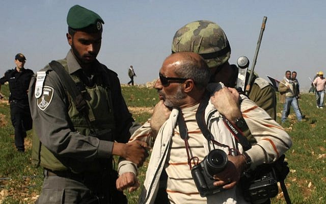 Israeli security detain The Associated Press photographer Nasser Shiyoukhi during a Palestinian protest in Yatta in the West Bank on Saturday. Shiyoukhi was released without charge after Saturday’s incident. (photo credit: AP Photo) Israeli security detain The Associated Press photographer Nasser Shiyoukhi during a Palestinian protest in Yatta in the West Bank on Saturday. Shiyoukhi was released without charge after Saturday’s incident. (photo credit: AP Photo)