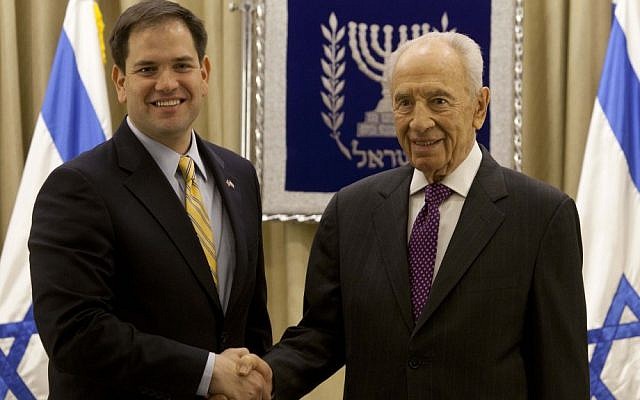 President Shimon Peres, right, shakes hands for photographers with Republican Senator Marco Rubio during their meeting in Jerusalem in February, 2013 (photo credit: AP/Sebastian Scheiner)