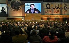 Hezbollah leader Sheik Hassan Nasrallah speaks via a video link, during a ceremony to mark the anniversary of the death of Hezbollah leaders, in the southern suburbs of Beirut, Lebanon, Saturday, Feb. 16, 2013 (photo credit: Bilal Hussein/AP)