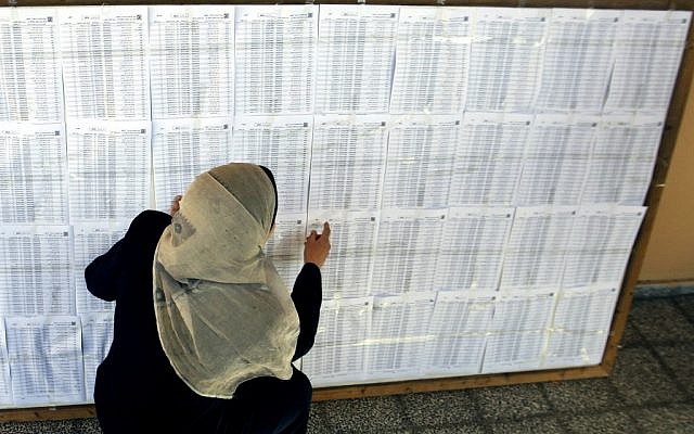A Palestinian woman points at a voters list in Gaza City, Monday, Feb. 11 (photo credit: AP/Hatem Moussa)