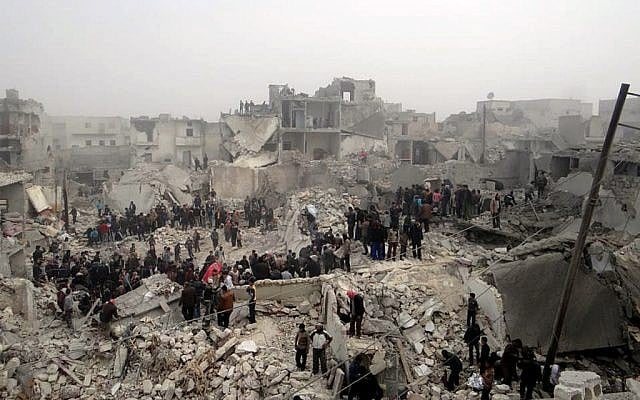 People searching through the debris of destroyed buildings in the aftermath of a strike by Syrian government forces, in the neighborhood of Jabal Bedro, Aleppo, Syria, February 19 (photo credit: AP/Aleppo Media Center AMC) People searching through the debris of destroyed buildings in the aftermath of a strike by Syrian government forces, in the neighborhood of Jabal Bedro, Aleppo, Syria, February 19 (photo credit: AP/Aleppo Media Center AMC)