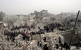 Syrian civilians searching through the debris of destroyed buildings in the aftermath of a strike by Syrian government forces, in the neighborhood of Jabal Bedro, Aleppo, Syria, Tuesday Feb. 19 (photo credit: AP/Aleppo Media Center)