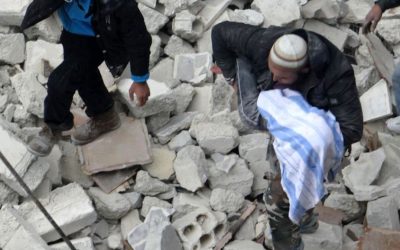 A man carries a body among ruins in the Syrian city of Aleppo, Sunday (photo credit: Aleppo Media Center AMC/AP)