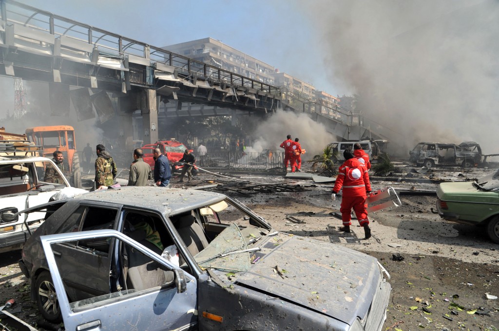 First responders working after a huge explosion that shook central Damascus, Syria, Thursday, Feb. 21, 2013 (photo credit: (AP/SANA)