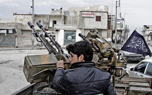 A Free Syrian Army fighter sits behind an anti-aircraft weapon in Aleppo, Syria (photo credit: AP/Abdullah al-Yassin)