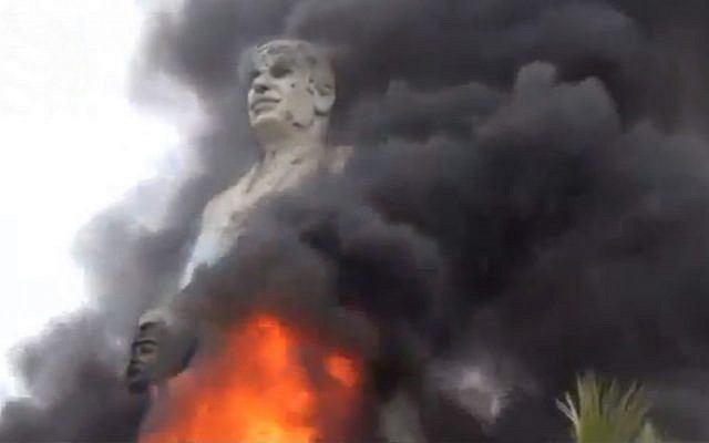 A statue of Hafez Assad, father of Syrian President Bashar Assad, burns after being set on fire by rebel fighters inside the grounds of the General Company of the Euphrates Dam in al-Raqqa, Syria, on Monday, February 11, 2013. (AP Photo/Ugarit News via AP video) A statue of Hafez Assad, father of Syrian President Bashar Assad, burns after being set on fire by rebel fighters inside the grounds of the General Company of the Euphrates Dam in al-Raqqa, Syria, on Monday, February 11, 2013. (AP Photo/Ugarit News via AP video)