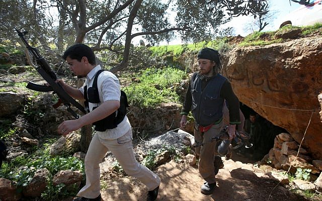 Free Syrian Army fighters from the Knights of the North brigade leave one of their caves to reconnaissance a Syrian army forces base of al-Karmid, at Jabal al-Zaweya, in Idlib province, Syria, Wednesday, Feb. 27 (Photo credit: AP/Hussein Malla) Free Syrian Army fighters from the Knights of the North brigade leave one of their caves to reconnaissance a Syrian army forces base of al-Karmid, at Jabal al-Zaweya, in Idlib province, Syria, Wednesday, Feb. 27 (Photo credit: AP/Hussein Malla)
