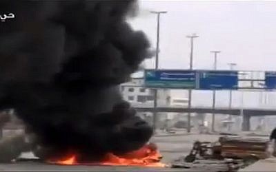 Smoke and fire rising on a main highway in Damascus, Syria on Friday, February 8 (photo credit: AP/Ugarit News)