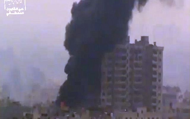 Smoke and fire billow from an explosion in Damascus, Syria, on Feb. 6, 2013 (photo credit: AP/Ugarit News via AP video) Smoke and fire billow from an explosion in Damascus, Syria, on Feb. 6, 2013 (photo credit: AP/Ugarit News via AP video)