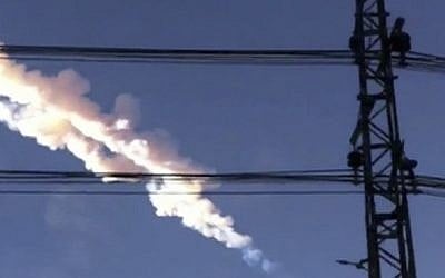 In this photo taken with a mobile phone camera, a meteorite contrail is seen in the Chelyabinsk region of Russia on February 15, 2013. (AP Photo/Sergey Hametov)