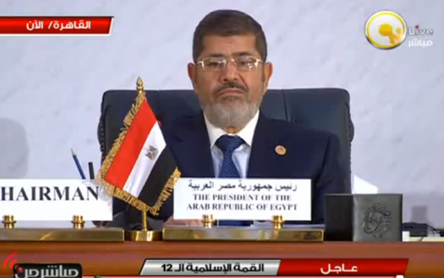 A visibly unamused Egyptian President Mohammed Morsi at Wednesday's meeting of the Organization of Islamic Cooperation summit in Cairo (photo credit: screen capture YouTube) A visibly unamused Egyptian President Mohammed Morsi at Wednesday's meeting of the Organization of Islamic Cooperation summit in Cairo (photo credit: screen capture YouTube)
