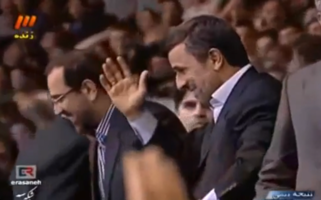 Iranian President Mahmoud Ahmadinejad waves to spectators at a wrestling match in Tehran on February 23, 2013. (photo credit: image capture/YouTube video)