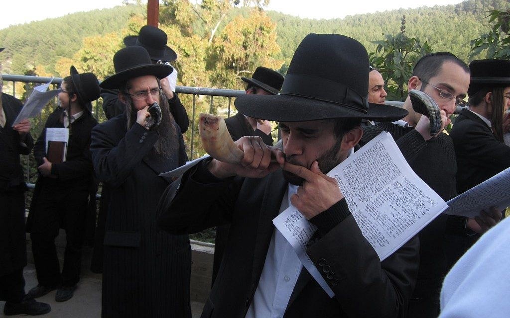 Unmarried men and their supporters blow shofars at the grave of Rabbi Yonatan ben Uziel near Safed. (Ben Sales/JTA) Unmarried men and their supporters blow shofars at the grave of Rabbi Yonatan ben Uziel near Safed. (Ben Sales/JTA)