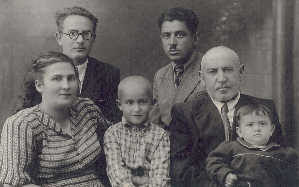 Sofia Greenberg, shown in 1952 in the lap of her grandfather, Berl, hopes to find her American cousins. (Courtesy of Sofia Greenberg via JTA) Sofia Greenberg, shown in 1952 in the lap of her grandfather, Berl, hopes to find her American cousins. (Courtesy of Sofia Greenberg via JTA)