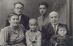 Sofia Greenberg, shown in 1952 in the lap of her grandfather, Berl, hopes to find her American cousins. (Courtesy of Sofia Greenberg via JTA)
