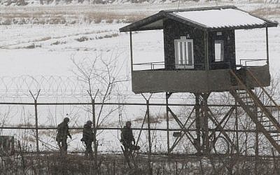 South Korean army soldiers patrol along a barbed-wire fence at the Imjingak Pavilion, near the demilitarized zone of Panmunjom, in Paju, South Korea, Tuesday. (photo credit: AP/Ahn Young-joon)