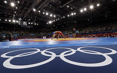 FILE - The Aug. 6, 2012 file photo shows Sayed Abdelmonem Hamed of Egypt competing against Zaur Kuramagomedov of Russia (in blue) during the 60-kg Greco-Roman wrestling competition at the 2012 Summer Olympics in London (AP Photo/Paul Sancya)