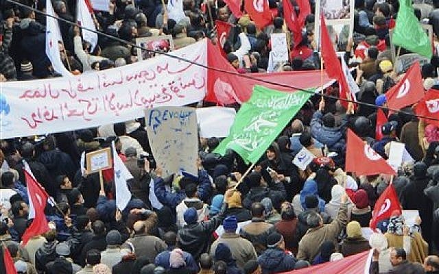Several thousand supporters of Tunisia's moderate Islamist party in a pro-government demonstration in Tunis a day after the funeral of an assassinated opposition politician, Feb 9, 2013. (photo credit: AP/Hassene Dridi)