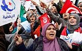 Supporter of the Islamist party Ennahda, hold Tunisian and party flags during a rally in Tunis, Tunisia on February 16, 2013. (photo credit: Amine Landouls/AP)