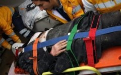 Medics and firefighters carry an injured woman into an ambulance after a suicide bomber detonated an explosive device at the entrance to the US Embassy in Ankara, Turkey, on Friday (photo credit: AP/Burhan Ozbilici)