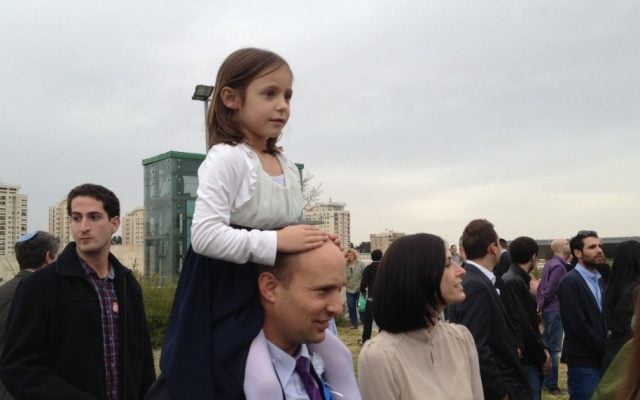 Jewish Home party chairman Naftali Bennett with one of his daughters at the Knesset swearing-in ceremony, Feb. 5, 2013 (photo credit: Raphael Ahren/Times of Israel)