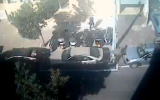 A city worker paints a handicapped space around Hila Ben Baruch's car in Tel Aviv (YouTube screenshot)