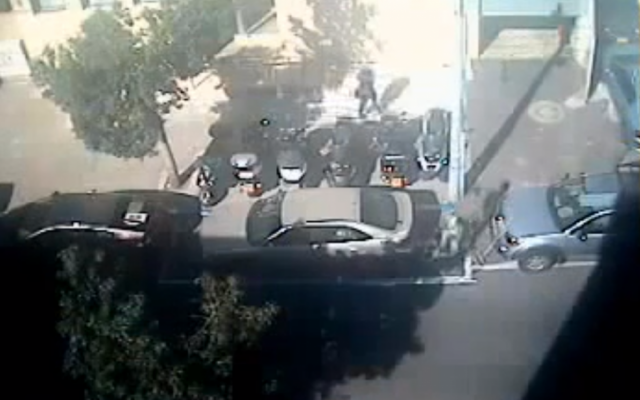 A city worker paints a handicapped space around Hila Ben Baruch's car in Tel Aviv (YouTube screenshot) A city worker paints a handicapped space around Hila Ben Baruch's car in Tel Aviv (YouTube screenshot)