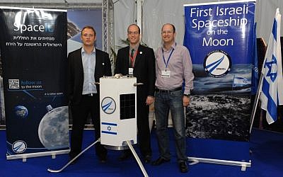 Three of SpaceIL's founders -- Yariv Bash, Yonatan Winetraub, and Kfir Damari -- with a model of the spacecraft they propose to send to the moon (photo credit: Alon Hadar)
