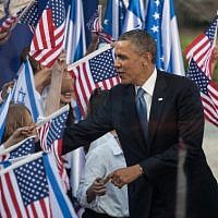 US President Barack Obama (left) and President Shimon Peres are greeted by children waving Israeli and American flags at a welcoming ceremony held for Obama in Jerusalem in March. (photo credit: Uri Lenz/Flash90)