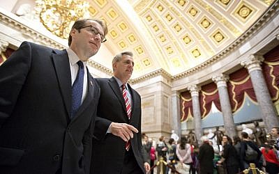 Rep. Peter Roskam, R-Ill., left, and House Majority Whip Kevin McCarthy of Calif., shuttle between the House floor and the offices of House Speaker John Boehner, on Capitol Hill in Washington, Friday, Jan. 4 (photo credit: AP/J. Scott Applewhite)