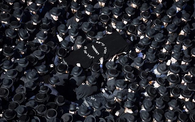 Members of the Satmar Orthodox Jewish community in Brooklyn, NY, carry a casket to the funeral of two expectant parents who were killed in a car accident on Sunday (photo credit: AP/John Minchillo)