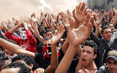Fans from Egypt's Al-Ahly soccer club celebrate in Cairo on March 9, 2013, after a court confirms death sentences for 21 people over their roles in the deadly 2012 riot in Port Said that left more than 70 people dead. (AP Photo/Amr Nabil)