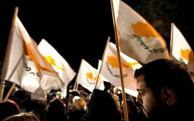 Protestors hold Cyprus' flags during a rally outside the parliament in capital Nicosia, Cyprus, Friday, March 22, 2013. (photo credit: AP/Petros Karadjias)