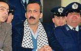 Mohammed Rashed, center, convicted of the 1982 Pan Am jetliner bombing, listens to his unidentified PLO interpreter, left, during his appeals court hearing in Athens, Greece in December 1991 (photo credit: AP/Aris Saris, File)