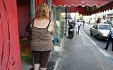 A woman stands outside an alleged brothel in south Tel Aviv (photo credit: Kobi Gideon/Flash90/File)