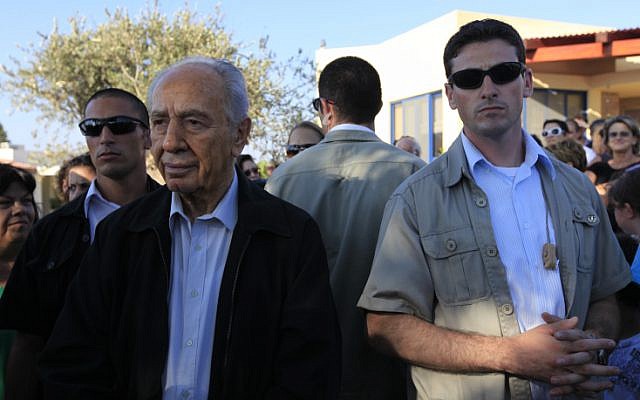 President Shimon Peres is surrounded by bodyguards during a visit to Kibbutz Kfar Aza in 2009 (photo credit: Tsafrir Abayov/Flash90) President Shimon Peres is surrounded by bodyguards during a visit to Kibbutz Kfar Aza in 2009 (photo credit: Tsafrir Abayov/Flash90)