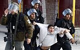 A Palestinian youth is arrested by Israeli Border Policemen following clashes with Israeli forces, February 2010. (Abir Sultan/Flash90)