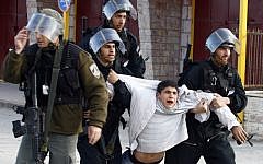 A Palestinian youth is arrested by Israeli Border Policemen following clashes with Israeli forces, February 2010. (Abir Sultan/Flash90)