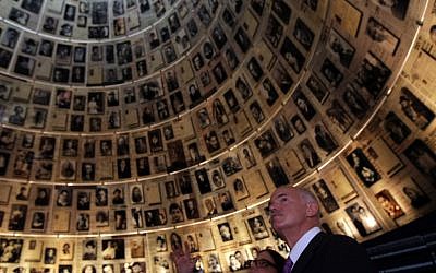 Former Greek prime minister George Papandreou looks at the photographs displayed in the Hall of Names at Yad Vashem to commemorate the six million Jews killed by the Nazis during World War II. (photo credit: Kobi Gideon/Flash90)