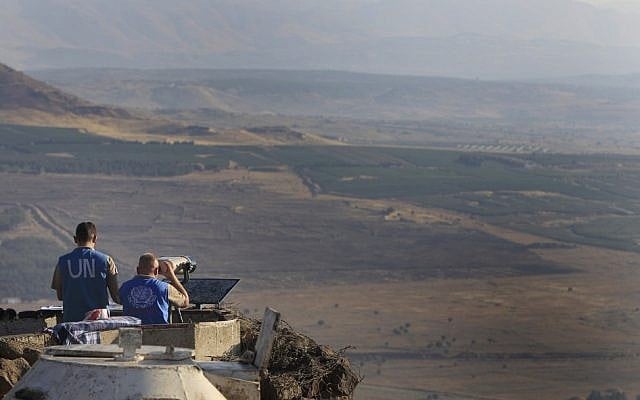 UN peacekeepers monitor the Syrian side of the border from an Israeli army post at Mount Bental near Kibbutz Merom Golan in the Golan Heights in July 2012. (photo credit: Tsafrir Abayov/Flash90) UN peacekeepers monitor the Syrian side of the border from an Israeli army post at Mount Bental near Kibbutz Merom Golan in the Golan Heights in July 2012. (photo credit: Tsafrir Abayov/Flash90)
